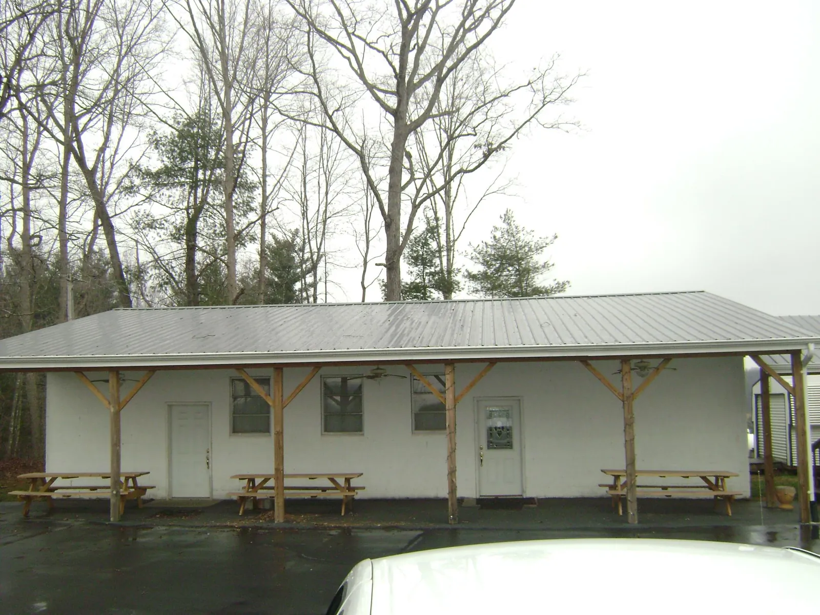 Gray metal roof over a block building with a timber post porch in Pembroke